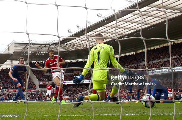 Rudy Gestede of Middlesbrough scores his sides first goal past David De Gea of Manchester United during the Premier League match between...