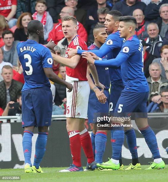 Eric Bailly of Manchester United is calmed down by Ben Gibson of Middlesbrough after clashing with Rudy Gestede during the Premier League match...