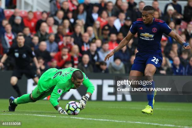 Middlesbrough's Spanish goalkeeper Víctor Valdes slips to let Manchester United's Ecuadorian midfielder Antonio Valencia walk in their third goal...