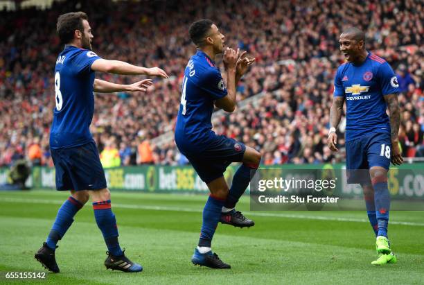 Jesse Lingard of Manchester United celebrates scoring his sides second goal with Juan Mata of Manchester United and Ashley Young of Manchester United...