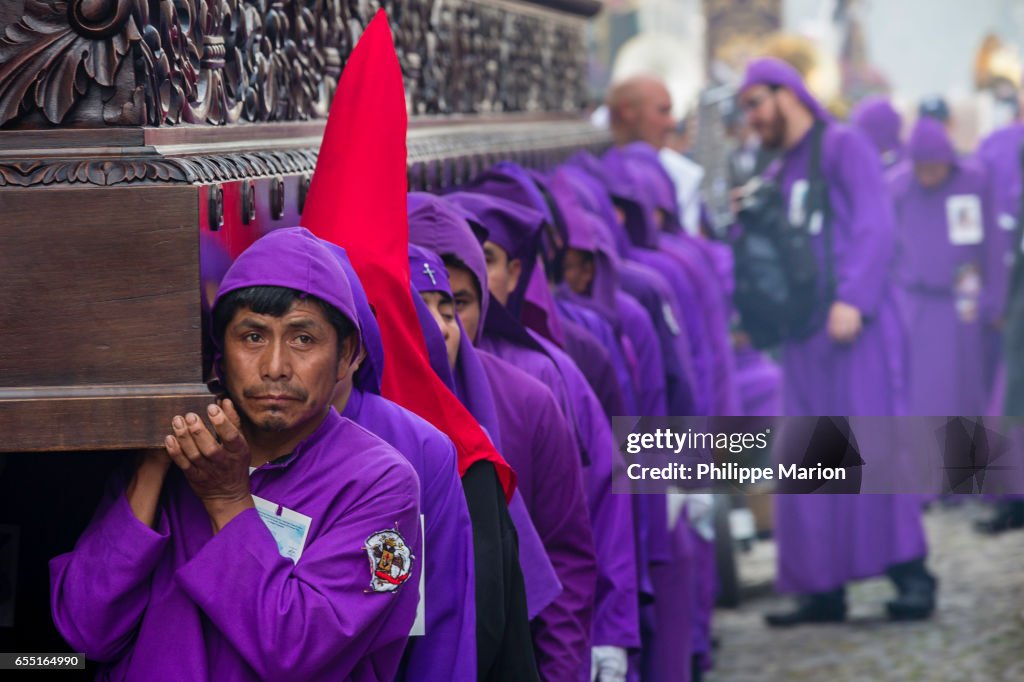 Santa Semana procession participants straining under weight of religious float (anda) -  Antigua, Guatemala