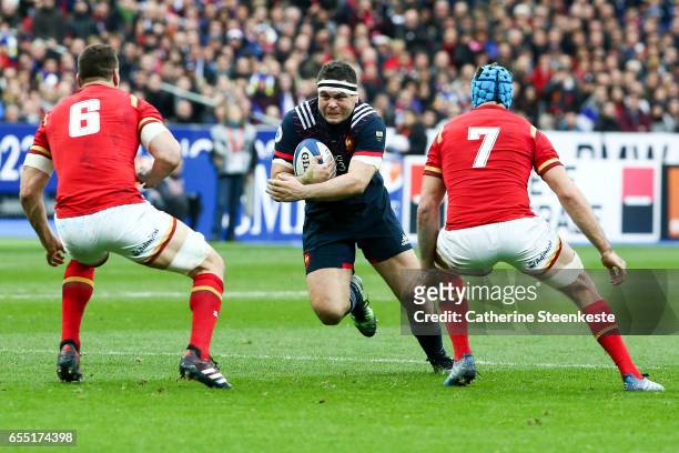 Guilhem Guirado of France is running with the ball against Sam Warburton and Justin Tipuric of Wales during the RBS Six Nations match between France...