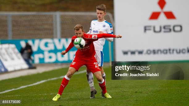 Nico Neidhart of Lotte challenges Fabian Baumgaertel of Halle during the third league match between Sportfreunde Lotte and Hallescher FC at Frimo...