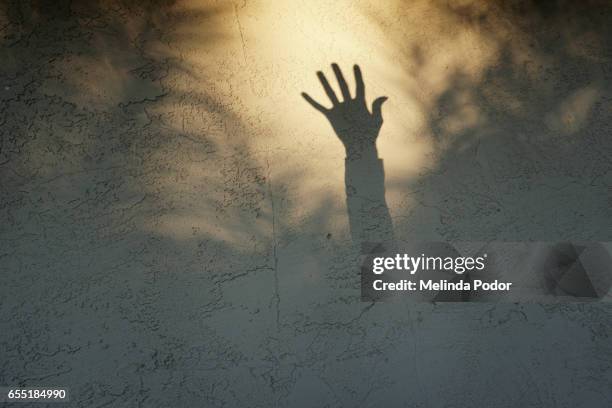 shadow of a hand reaching up - invisible stock pictures, royalty-free photos & images