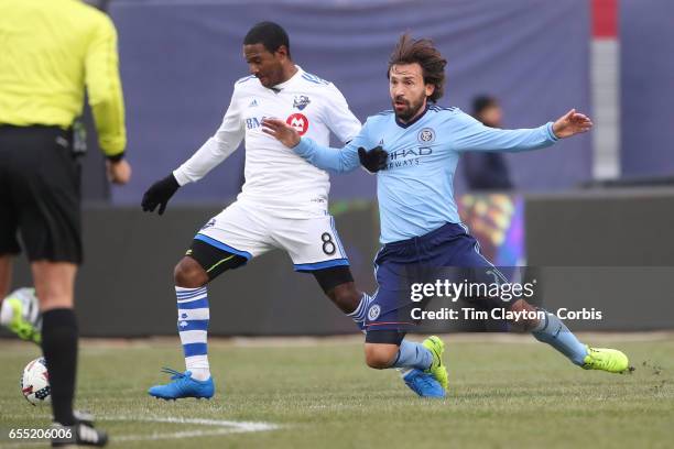 March 18: Andrea Pirlo of New York City FC is pushed off the ball by Patrice Bernier of Montreal Impact during the New York City FC Vs Montreal...