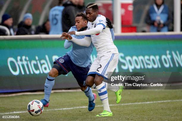 March 18: Ambroise Oyongo of Montreal Impact is challenged by Jonathan Lewis of New York City FC during the New York City FC Vs Montreal Impact...