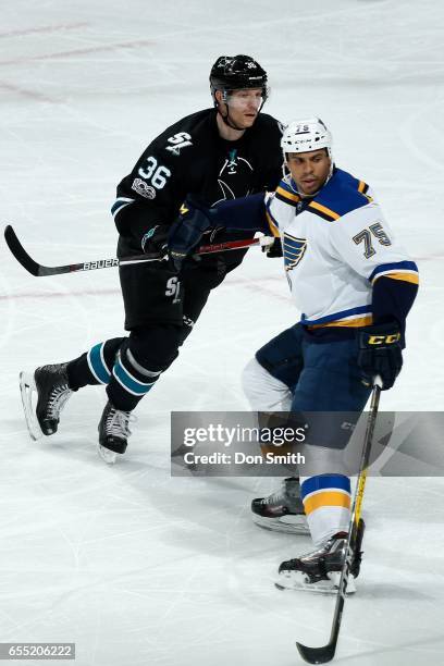 Jannik Hansen of the San Jose Sharks and Ryan Reaves of the St. Louis Blues look during a NHL game at SAP Center at San Jose on March 16, 2017 in San...