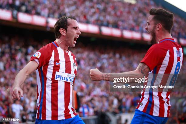 Diego Godin of Atletico de Madrid celebrates scoring their opening goal with teammate Saul Niguez during the La Liga match between Club Atletico de...