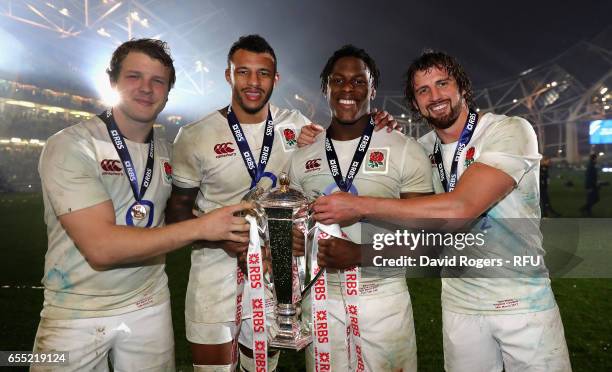 Joe Launchbury, Courtney Lawes, Maro Itoje and Tom Wood of England hold the Six Nations trophy after the RBS Six Nations match between Ireland and...