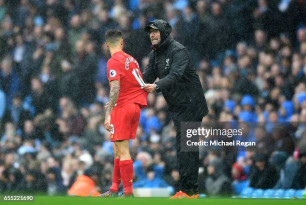 Jurgen Klopp, Manager of Liverpool speaks to Philippe Coutinho of Liverpool during the Premier League match between Manchester City and Liverpool at...