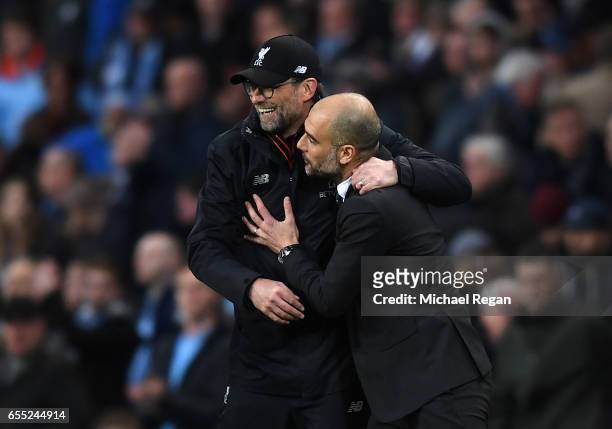 Jurgen Klopp, Manager of Liverpool and Josep Guardiola, Manager of Manchester City embrace after the Premier League match between Manchester City and...