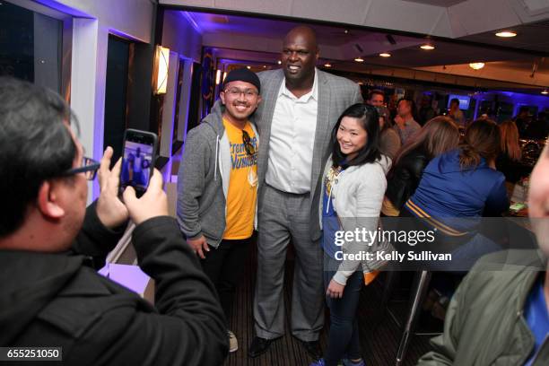 Golden State Warriors legend Adonal Foyle poses for photos with fans at the third American Express "All for Dub Nation" Watch Party on the S.S. Dub...