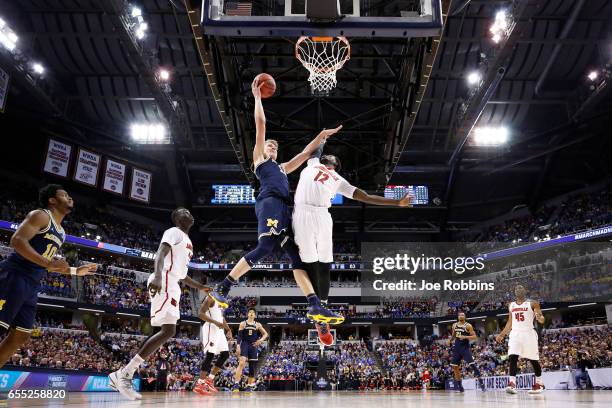 Moritz Wagner of the Michigan Wolverines drives to the basket against Mangok Mathiang of the Louisville Cardinals during the second round of the 2017...