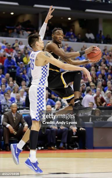 Markis McDuffie of the Wichita State Shockers goes up for a shot against Derek Willis of the Kentucky Wildcats in the first half during the second...