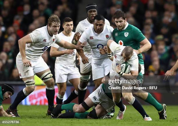 Mike Brown of England is tackled during the RBS Six Nations match between Ireland and England at the Aviva Stadium on March 18, 2017 in Dublin,...