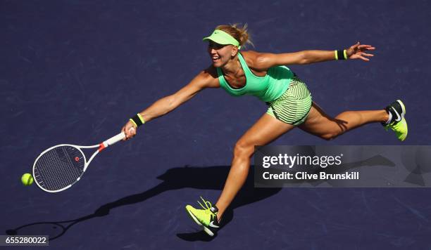 Elena Vesnina of Russia plays a forehand volley against Svetlana Kuznetsova of Russia in the womens final during day fourteen of the BNP Paribas Open...