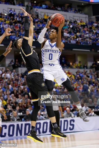 De'Aaron Fox of the Kentucky Wildcats shoots against Landry Shamet of the Wichita State Shockers in the first half during the second round of the...