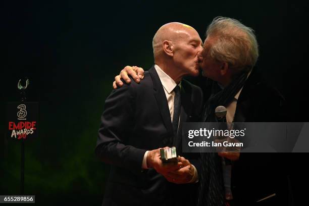 Sir Ian McKellen kisses Sir Patrick Stewart as he presents the award for Empire Legend to Stewart during the THREE Empire awards at The Roundhouse on...