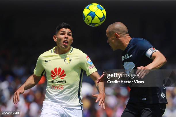 Silvio Romero of Americaa struggles for the ball with Dario Veron of Pumas during the 11th round match between Pumas UNAM and America as part of the...