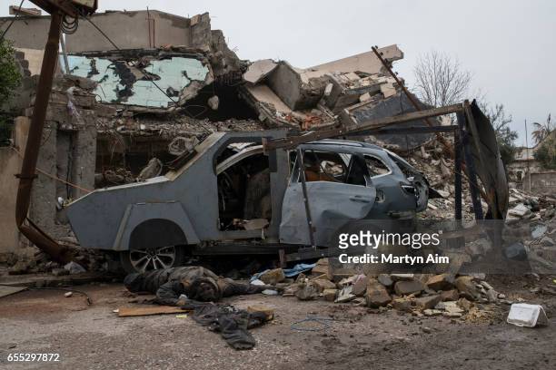 Dead Islamic State militant beside the suicide car bomb he failed to detonate in Hay Tayran, west Mosul, March 18, 2017. Iraqi forces continue their...