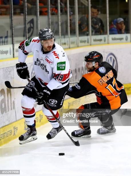 Sebastian Furchner of Wolfsburg and Alexandre Bolduc of Koeln battle for the puck during the DEL Playoffs quarter finals Game 6 between Grizzlys...