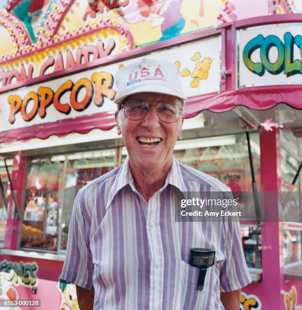 man near fairground ride - amusement park sign stock pictures, royalty-free photos & images