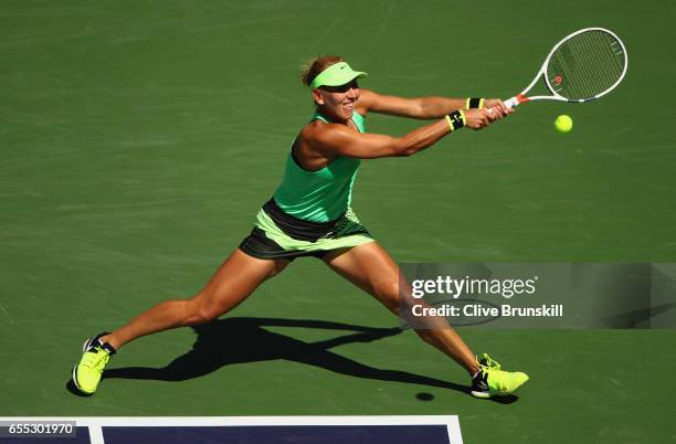 Elena Vesnina of Russia plays a backhand against Svetlana Kuznetsova of Russia in the womens final during day fourteen of the BNP Paribas Open at...