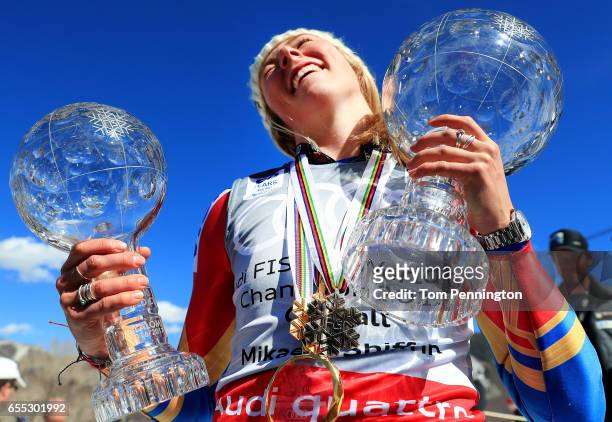Mikaela Shiffrin of United States celebrates with the globes for being awarded the overall season ladies' champion and lasies' season slalom champion...