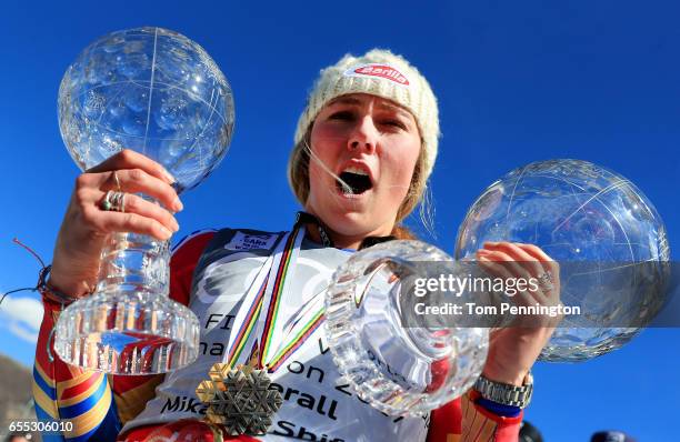 Mikaela Shiffrin of the United States celebrates with the globes for being awarded the overall season ladies' champion and lasies' season slalom...