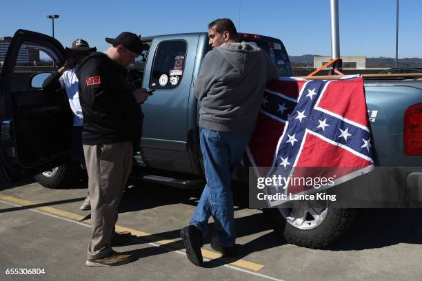 Members of the South Carolina Secessionist Party prepare to fly a Confederate battle flag in a parking garage beside the Bon Secours Wellness Arena...