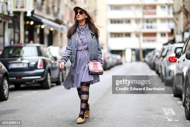 Bouchra Benhalima Bouasria, blogger from Boubou Tea Time, wears an H&M cap, an H&M dress, a Farah Asmar bag, Tods beige shoes, Calzedonia striped...