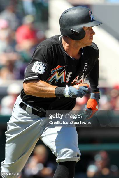 Matt den Dekker of the Marlins hustles down to first base during the spring training game between the Miami Marlins and the Detroit Tigers on March...