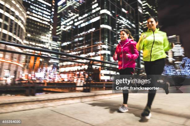 friends running in london in canary wharf