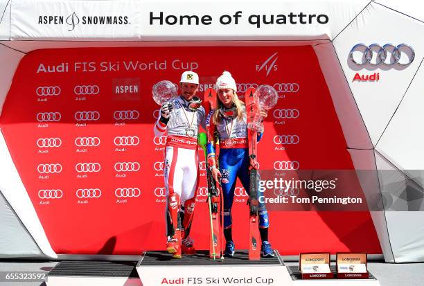 Marcel Hirscher of Austria and Mikaela Shiffrin of United States celebrates with the globes for being awarded the overall season men's and ladies'...