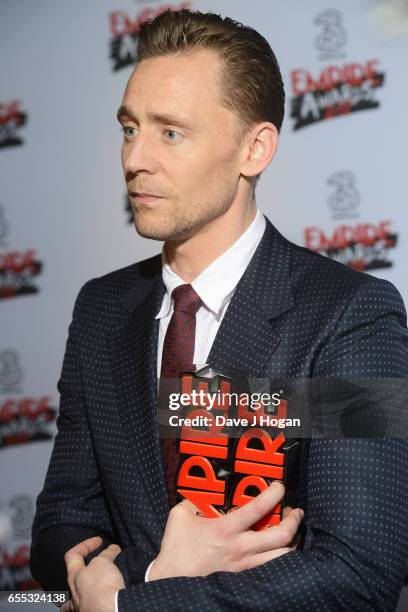 Tom Hiddleston poses with the awards for Empire Hero and Best TV Series - The Night Manager in the winners room at the THREE Empire awards at The...