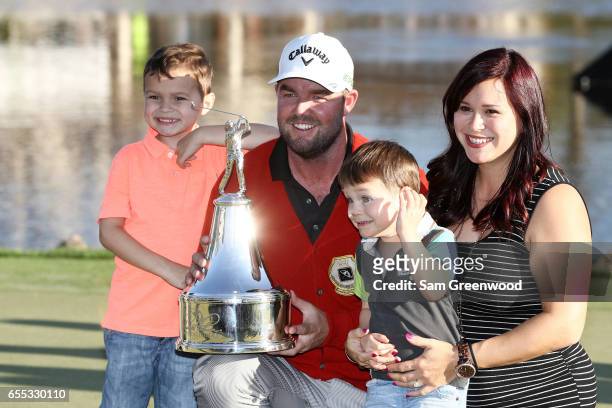 Marc Leishman of Australia celebrates with wife Audrey and children Oliver and Harry after finishing on the 18th green during the final round of the...