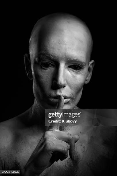 portrait of a white human - woman with finger on lips stock pictures, royalty-free photos & images