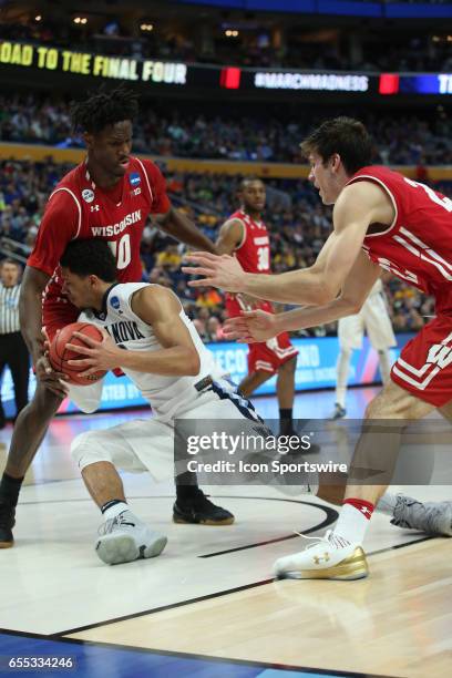 Villanova Wildcats guard Josh Hart stumbles while being defended Wisconsin Badgers forward Nigel Hayes during the NCAA Division 1 Men's Basketball...