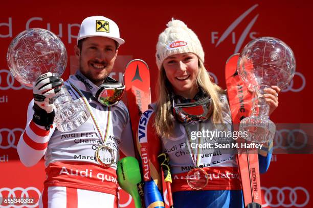 Marcel Hirscher of Austria and Mikaela Shiffrin of United States celebrates with the globes for being awarded the overall season men's and ladies'...