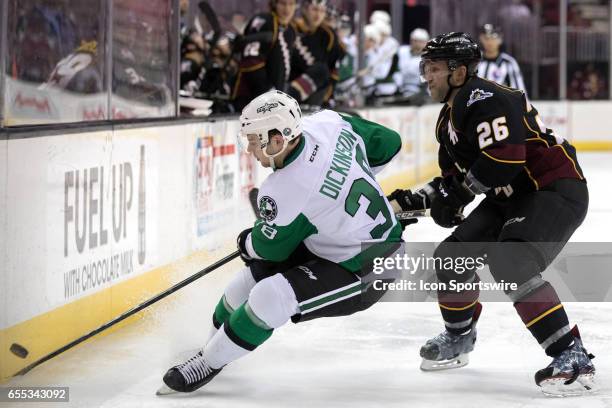 Texas Stars C Jason Dickinson plays the puck along the boards as Cleveland Monsters D Jaime Sifers defends during the second period of the AHL hockey...