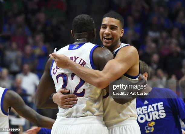 Dwight Coleby and Landen Lucas of the Kansas Jayhawks celebrate their victory over the Michigan State Spartans during the second round of the 2017...