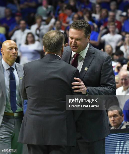 Head coach Tom Izzo of the Michigan State Spartans and Head coach Bill Self of the Kansas Jayhawks embrace after the game during the second round of...