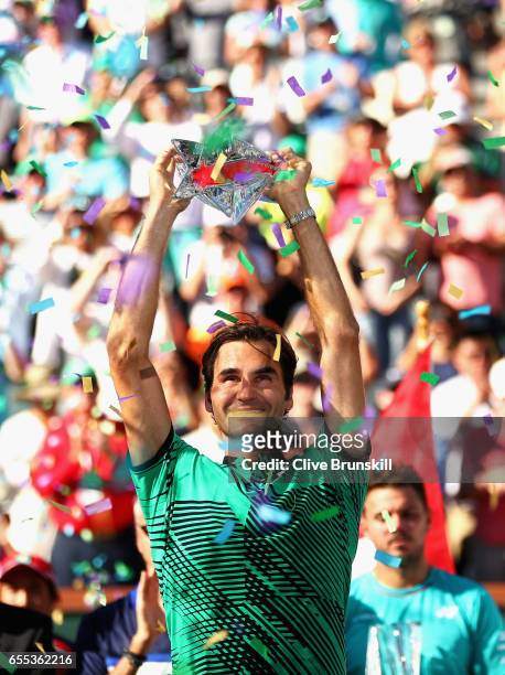 Roger Federer of Switzerland holds the BNP Paribas Open trophy aloft after his straight sets victory against Stanislas Wawrinka of Switzerland in the...