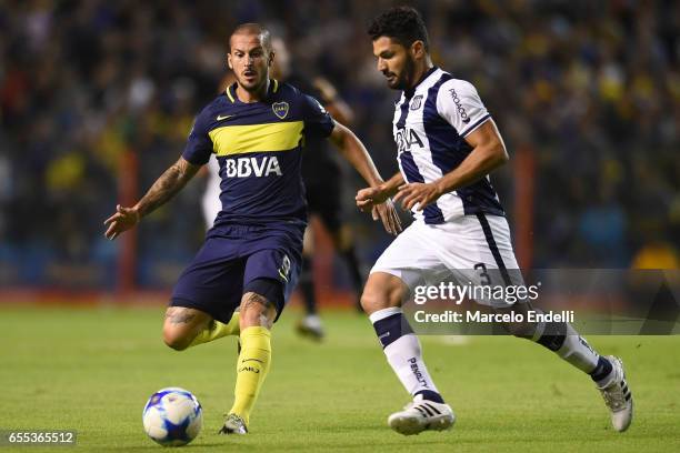 Dario Benedetto of Boca Juniors fights for ball with Javier Gandolfi of Talleres during a match between Boca Juniors and Talleres as part of Torneo...