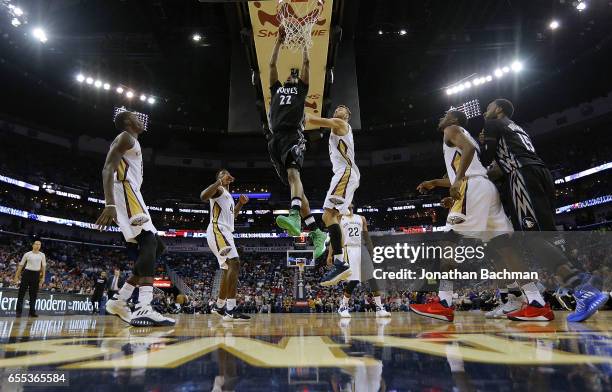 Andrew Wiggins of the Minnesota Timberwolves dunks over Donatas Motiejunas of the New Orleans Pelicans during the second half of a game at the...