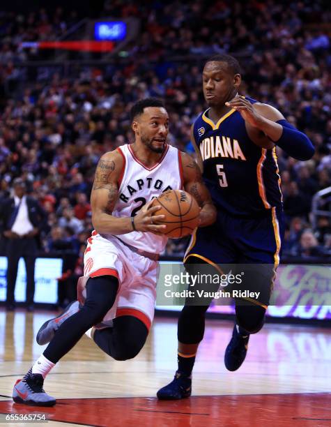 Norman Powell of the Toronto Raptors drives to the basket as Lavoy Allen of the Indiana Pacers defends during the second half of an NBA game at Air...