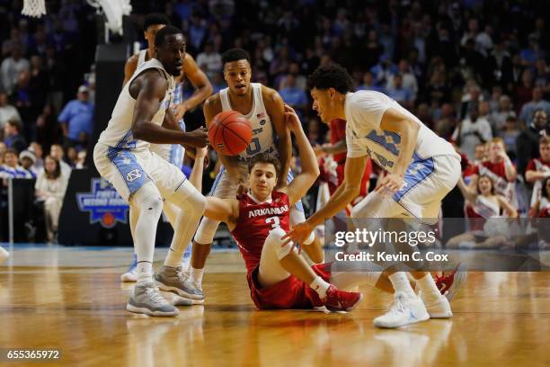 Theo Pinson of the North Carolina Tar Heels steals the ball from Dusty Hannahs of the Arkansas Razorbacks in the second half during the second round...