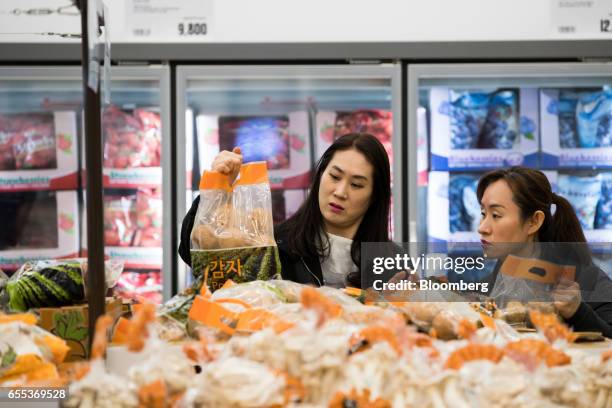 Customer inspects a bag of potatoes at an E-Mart Inc. Traders store in the Starfield Hanam shopping complex, operated by Shinsegae Co., in Hanam,...