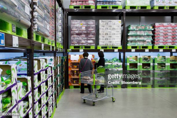 Customers inspect a package of paprikas at an E-Mart Inc. Traders store in the Starfield Hanam shopping complex, operated by Shinsegae Co., in Hanam,...
