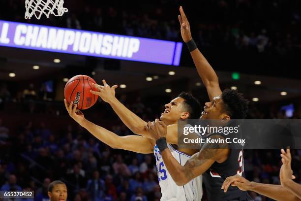 Frank Jackson of the Duke Blue Devils drives to the basket against Chris Silva of the South Carolina Gamecocks in the first half during the second...